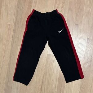Nike Kids Black Joggers with Red Stripes